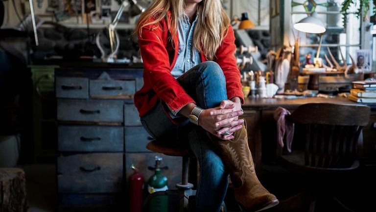 Image of Jillian Lukiwski sitting in a studio. 