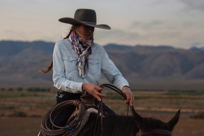 woman on a horse lassoing