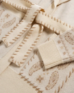 Closeup detail view of Women's Shawl Collar Wrap Sweater - Cream / Tan