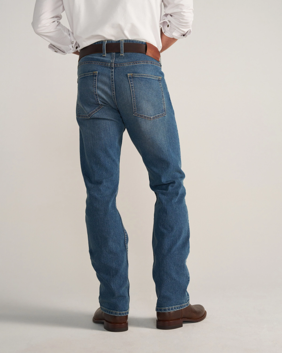 Back view of Men's Slim Straight Stretch Denim - Medium Indigo on model