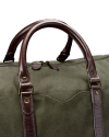 A green canvas duffel bag with brown leather handles and straps, shown against a black background.