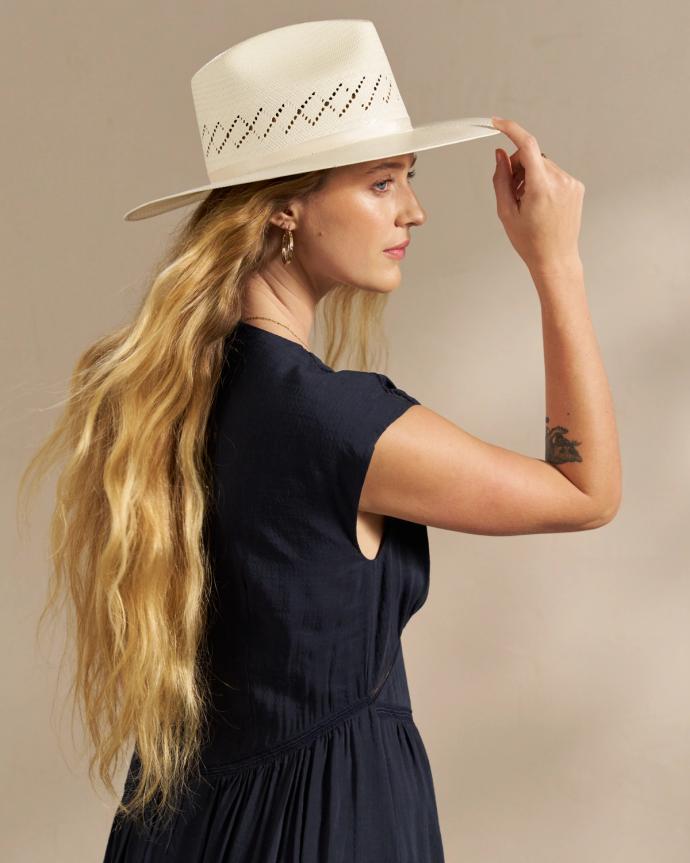 Closeup of woman wearing a straw hat in a photo studio