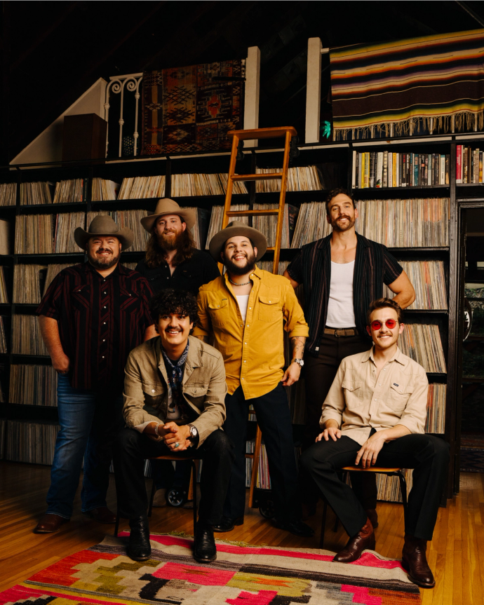 A band posing for a picture in a room.