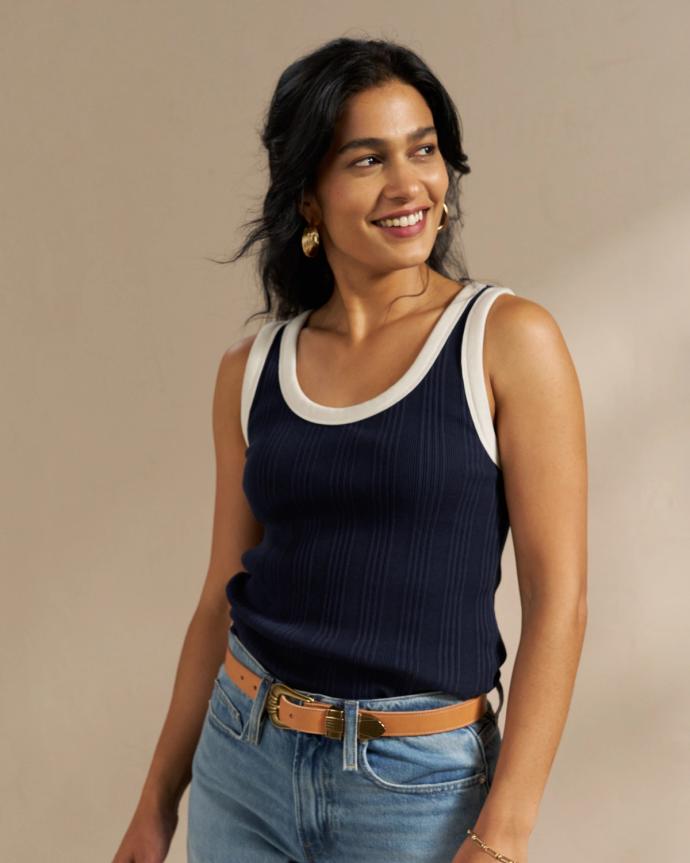 Woman wearing the ribbed tank in navy in a studio