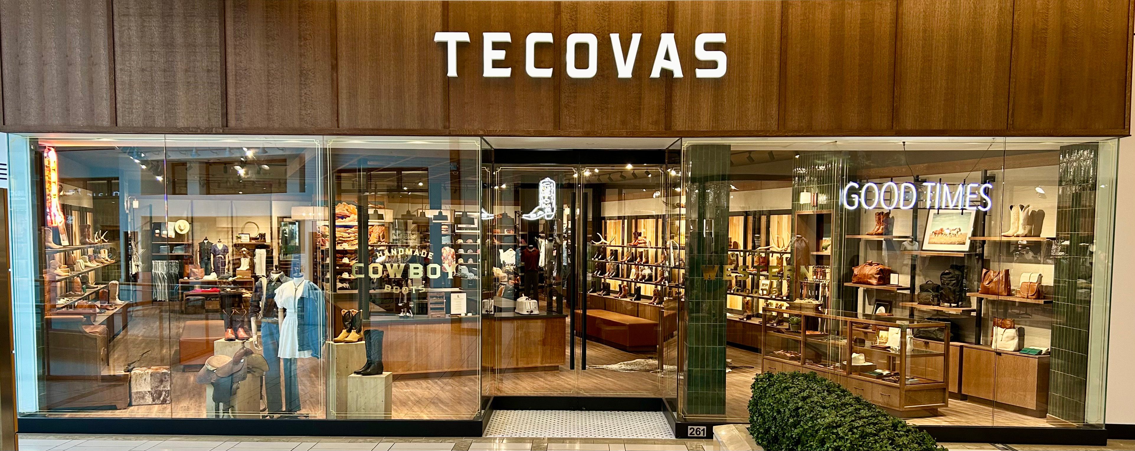 The image shows the word "Tecovas" written in a cursive font on a patchwork background of various shades of brown leather.