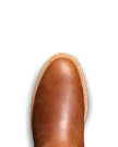 Close-up of a brown leather shoe's toe with stitching detail against a solid black background.