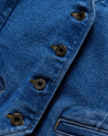 Zoomed in view of the buttons on the Women's Denim Vest in the color medium wash.