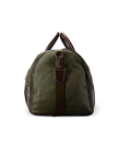Green canvas duffel bag with brown leather accents and handles, standing upright against a black background.
