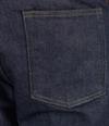 Person wearing dark blue denim jeans and a white shirt, shown from the back, with a brown leather patch on the waistband near the right hip.