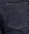Person wearing dark blue denim jeans and a white shirt, shown from the back, with a brown leather patch on the waistband near the right hip.