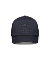 A black baseball cap with the text "Tecovas Quality Made Western Austin, Tex." on the front. It features a mesh back and a rope across the brim.