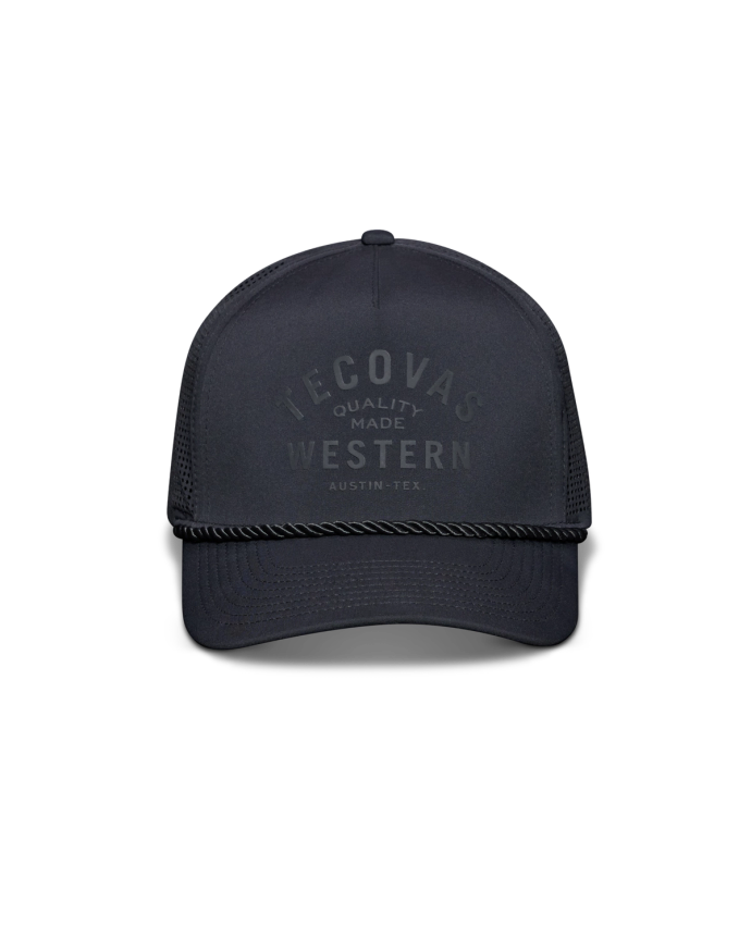 A black baseball cap with the text "Tecovas Quality Made Western Austin, Tex." on the front. It features a mesh back and a rope across the brim.