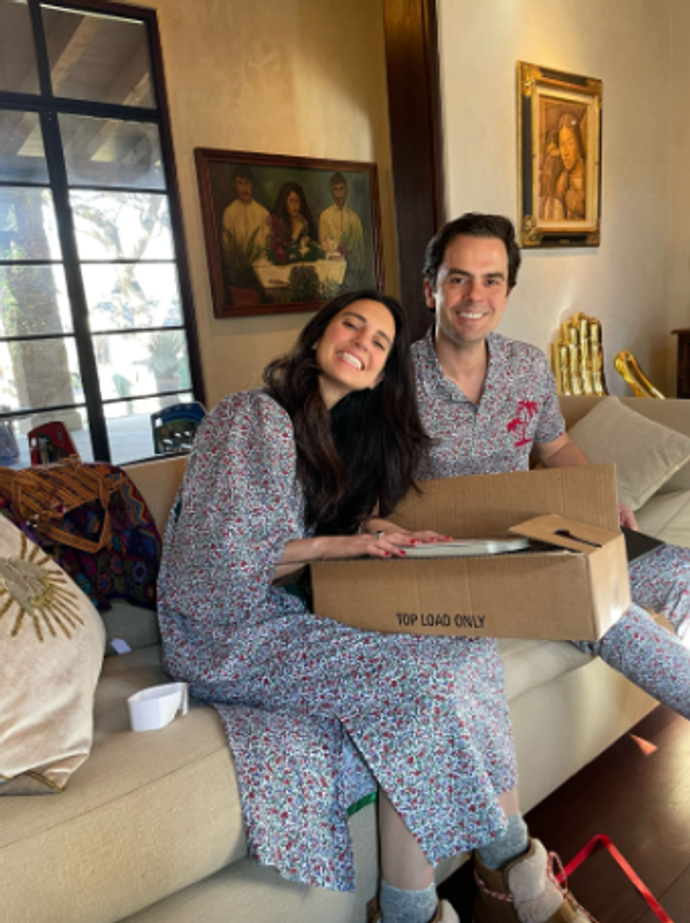 A woman and man opening Christmas presents together