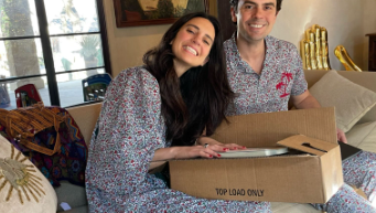 A woman and man opening Christmas presents together