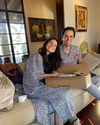 A woman and man opening Christmas presents together