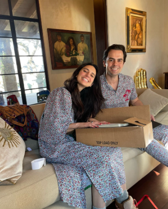 A woman and man opening Christmas presents together
