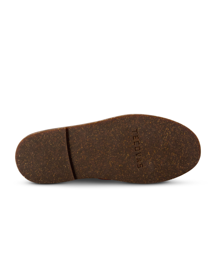 A brown shoe sole with a slight texture and the word "TEDOINS" engraved on it.