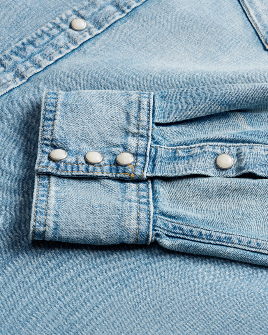 Closeup detail view of Men's Denim Pearl Snap LS - Light Wash