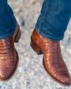 close up picture of Dillon Pecan brown cowboy boots on a man's feet