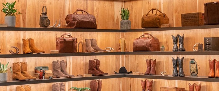 Image of wall shelves with cowboy boots. 