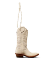 A single beige cowboy boot with a low wooden heel and decorative stitching, hanging upright by a loop of white rope against a plain white background.