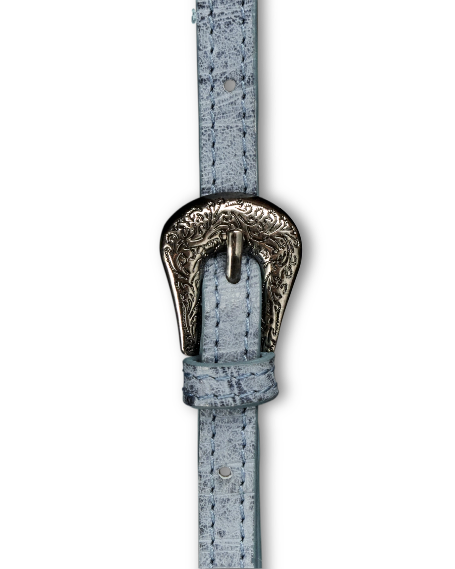 Close-up of a light blue textured belt with an ornate silver buckle featuring decorative engravings.