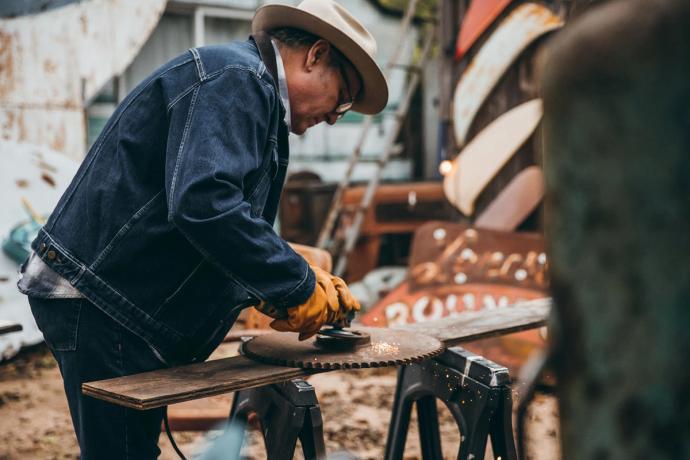 man working with an electric sander