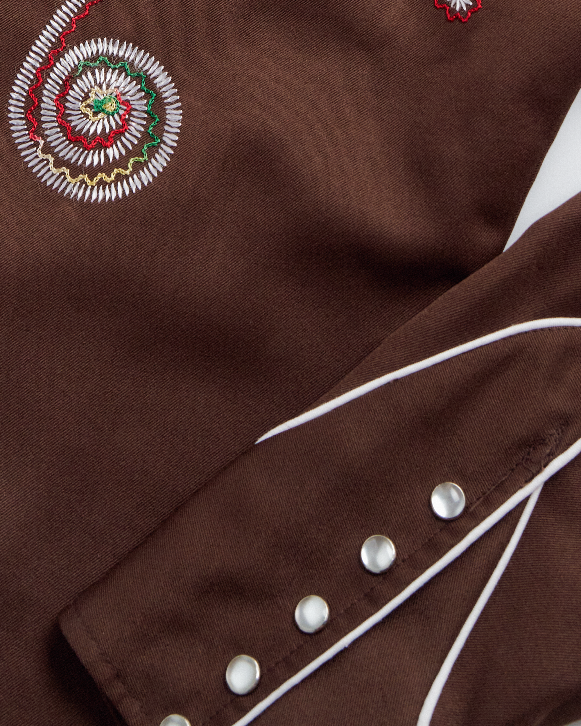 Closeup detail view of Tecovas x Cathy Hahn Men’s Vintage Smile Pocket Pearl Snap - Chocolate / Multi