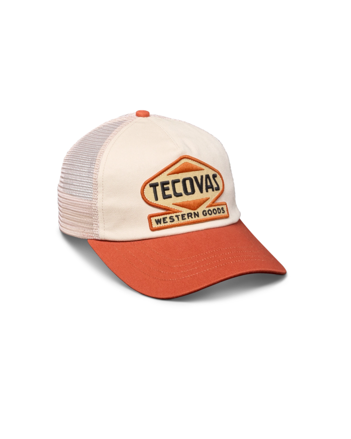 Quarterfront view of Tecovas Western Goods Patch Trucker Hat - White / Orange on plain background