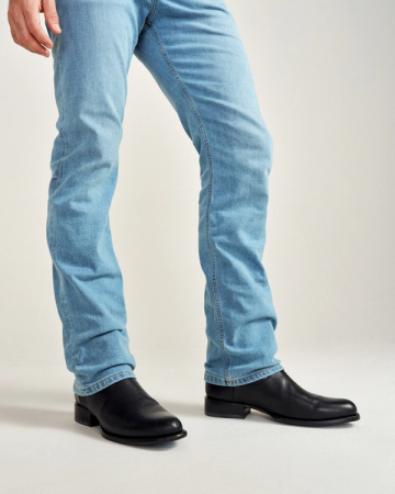 close up picture of Earl midnight black cowboy boots on a man's feet