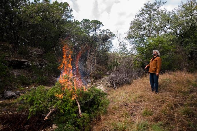 man watching a smoke from a bonfire