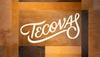 A wall with various shades of brown leather panels featuring the word "Tecovas" in white script lettering.