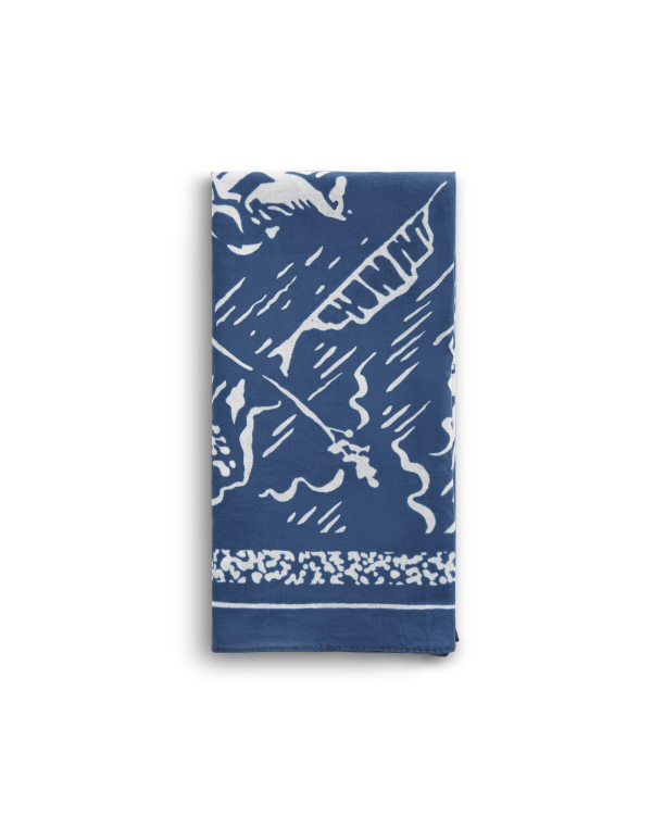 A folded blue and white cloth napkin featuring an abstract pattern with leafy and wavy designs.