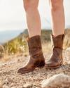 Person wearing the Tecovas Beth boot that has a "roper heel."