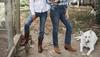 Two women in jeans and boots with a dog