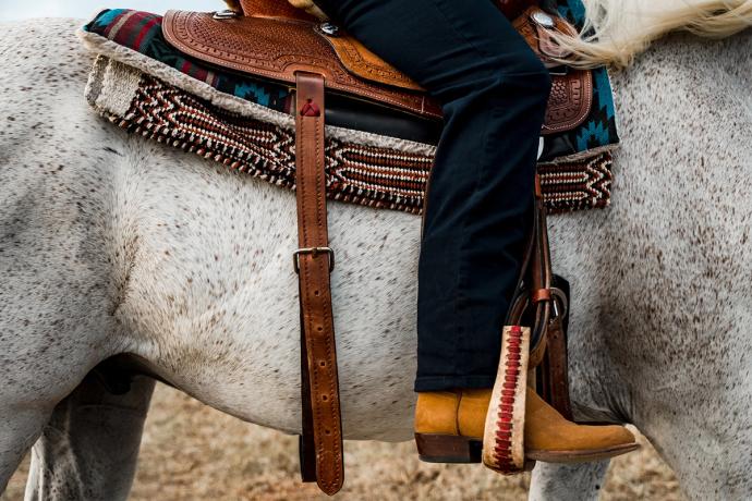 foot in stirrup on horse