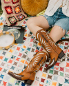 Brown boots with design on a picnic blanket 