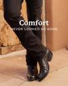 A person wearing black pants and stylish black cowboy boots stands with legs crossed below the text "Comfort never looked so good." Wooden door and adobe wall in the background.