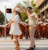 Couple dancing around in a street