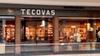 Storefront of Tecovas in a shopping mall, displaying boots, hats, and Western-style clothing inside with warm lighting.