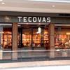 Storefront of Tecovas in a shopping mall, displaying boots, hats, and Western-style clothing inside with warm lighting.