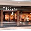 Storefront of Tecovas in a shopping mall, displaying boots, hats, and Western-style clothing inside with warm lighting.