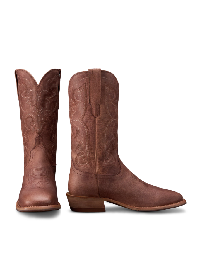 A pair of brown leather cowboy boots with decorative stitching, shown from the front and side against a white background.