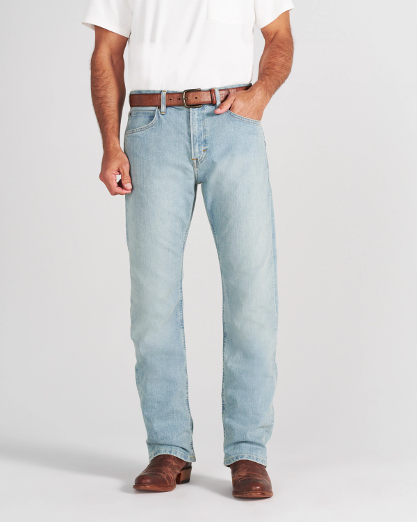 A man wearing a white t-shirt, brown leather belt, light-wash denim jeans, and brown leather boots.