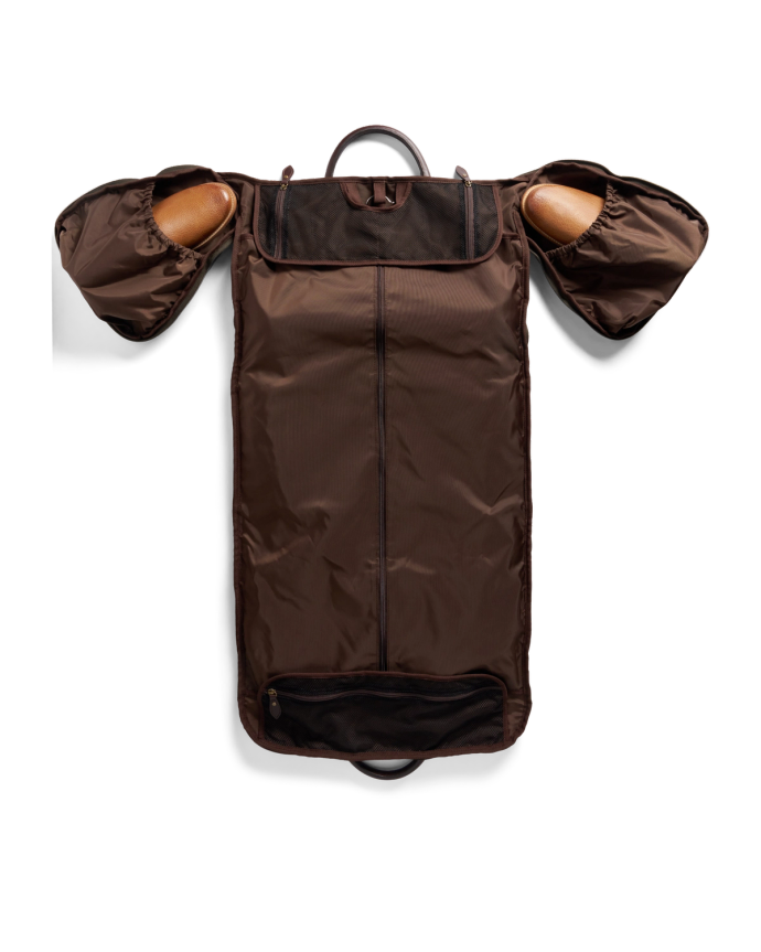 Brown garment bag with two zippered compartments for shoes, a central zip, and a top handle.