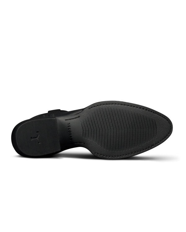 The Britt in Midnight Cowhide. The image shows the black rubber sole of The Britt Cowhide dress shoe, viewed from the bottom, featuring textured grip patterns and subtle branding near the heel.
