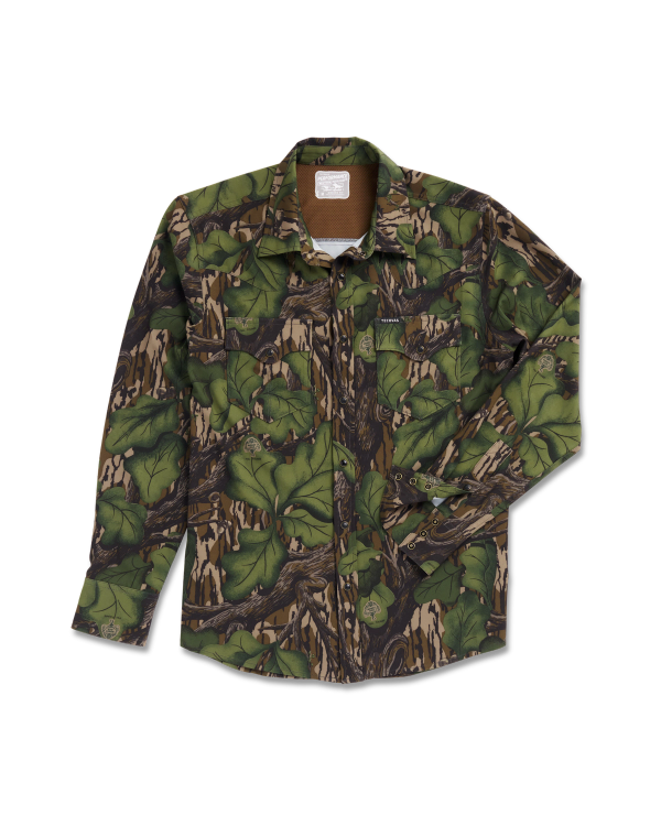 A long-sleeve button-up shirt with a green and brown camouflage pattern, featuring chest pockets, laid flat on a white background.