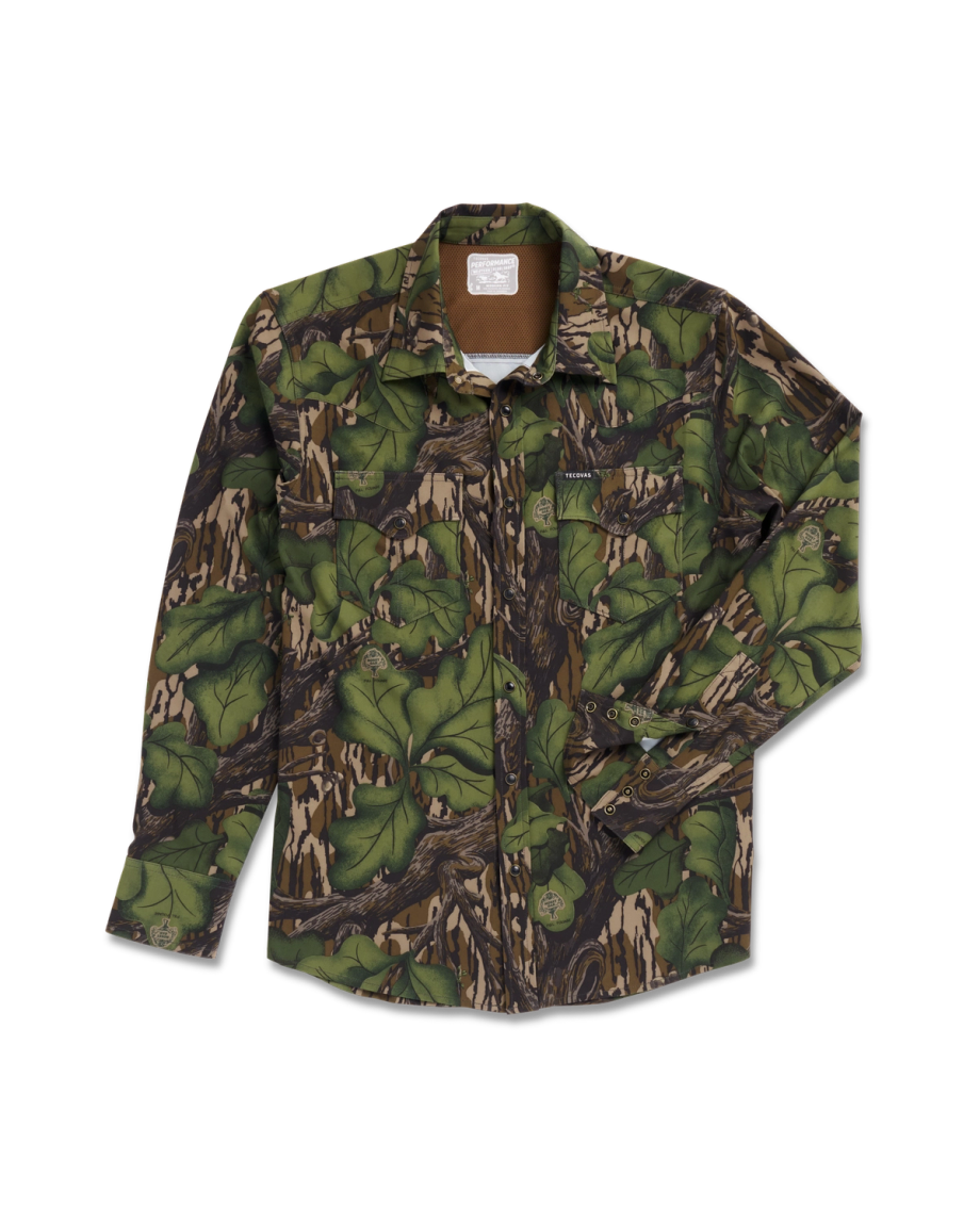 A long-sleeve button-up shirt with a green and brown camouflage pattern, featuring chest pockets, laid flat on a white background.