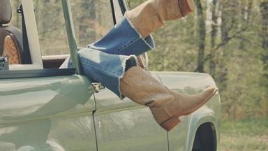 Image of woman wearing The Thomas Rhett Lauren Tecovas Boot in a car.