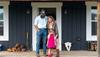 family standing on front steps